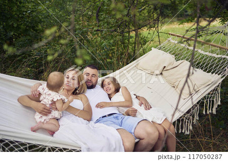 family mother father sister teenager and baby in hammock 117050287
