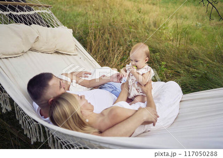 family mother father sister teenager and baby in hammock 117050288