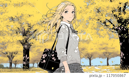 色づいたイチョウの木の下を歩く若い女性