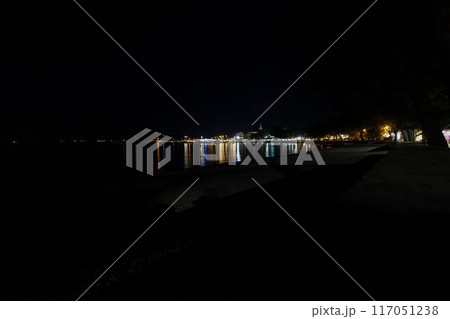 Night picture over the beach and the illuminated town of Fazana in Istria Night picture over the beach and the illuminated town of Fazana in Istria 117051238