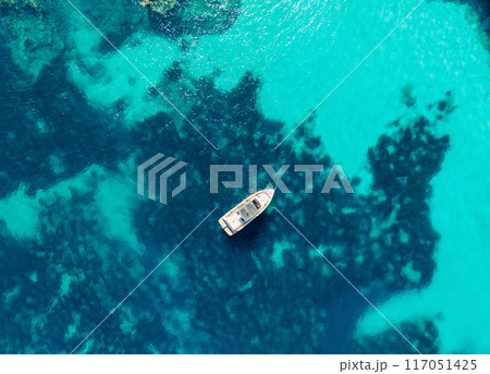 Aerial View of Boat in Crystal Clear Turquoise Waters 117051425