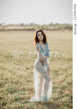 sexy topless nude girl posing in field in summer. Added the effect of a small film grain sexy topless nude girl posing in field in summer. Added the effect of a small film grain 117052402
