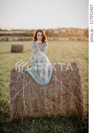 Sexy girl in underwear posing on a haystack in summer at sunset 117052407