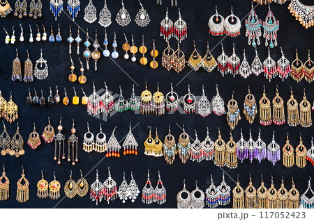 oriental Uzbek earrings in arabic ethnic style on black background in Uzbekistan 117052423