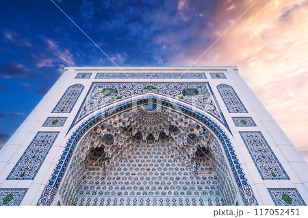 wall of Masjid Minor Mosque decorated ceramic white tiles with traditional oriental Arabic Uzbek ornaments in Tashkent in Uzbekistan 117052451