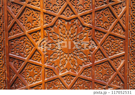 asian Uzbek patterns ornament on wooden carved door in Uzbekistan close-up 117052531