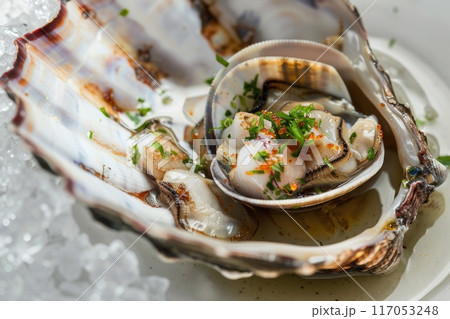 A shellfish dish with a garnish of parsley and a sprinkle of sesame seeds A shellfish dish with a garnish of parsley and a sprinkle of sesame seeds 117053248