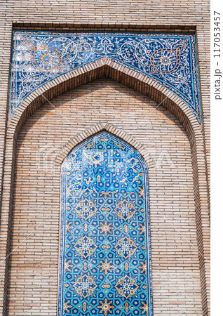 ancient ceramic tile with traditional Uzbek ornament Islamic pattern on wall of old Muslim mosque Hazrati Imam in Uzbekistan in Tashkent 117053457