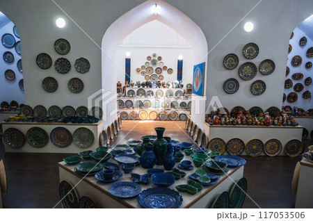 Souvenir shop with oriental Uzbek handmade ceramic plates, vases and dishes hand-painted Asian patterns Souvenir shop with oriental Uzbek handmade ceramic plates, vases and dishes hand-painted Asian patterns 117053506