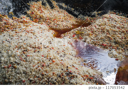 traditional oriental dish of Uzbek cuisine is rice pilaf with vegetables in cauldron in kitchen of an Asian restaurant in Tashkent in Uzbekistan close-up 117053542