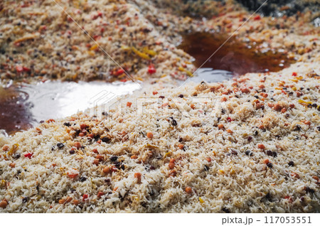 Uzbek cuisine is rice pilaf in a big cauldron in kitchen of an Asian restaurant in Tashkent Pilaf Center in Uzbekistan close-up 117053551