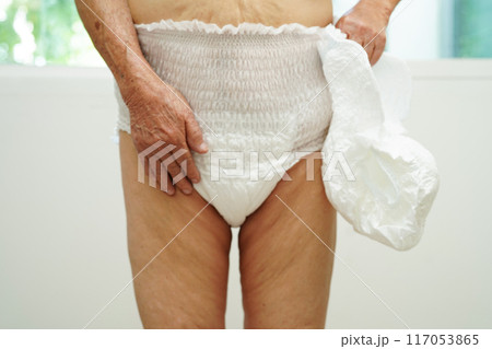 Asian senior woman patient wearing adult incontinence diaper pad in hospital. 117053865