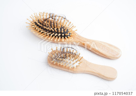 Asian woman have problem with long hair loss attach to comb brush. 117054037