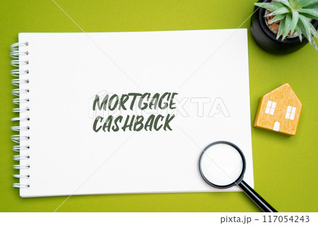 Mortgage cashback concept. Type of home loan where the borrower receives a lump sum of money upon closing the mortgage deal. Notes, magnifying glass and house Mortgage cashback concept. Type of home loan where the borrower receives a lump sum of money upon closing the mortgage deal. Notes, magnifying glass and house 117054243
