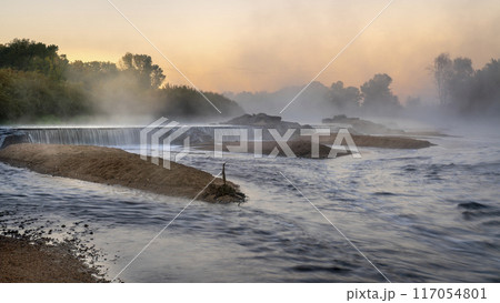 Mornig fog over a river diversion dam 117054801