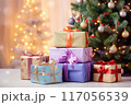 Holiday gifts arranged near a decorated tree, holiday background with copy space 117056539