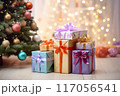 Colorful presents near a festive Christmas tree, holiday background with copy space 117056541