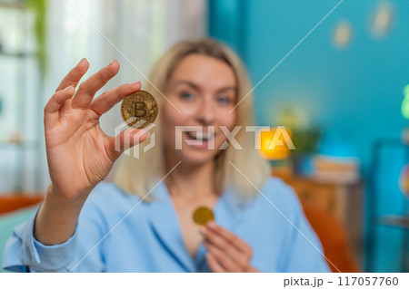 Business woman stock trader earning bitcoins after online monitoring trading operations crypto coins 117057760