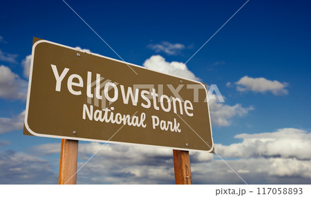 Yellowstone National Park (Wyoming, Montana, Idaho) Road Sign Against Blue Sky and Clouds. 117058893