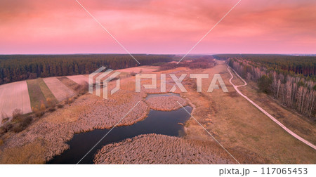 Beautiful pink sunset in the countryside in spring with the blazing sky 117065453