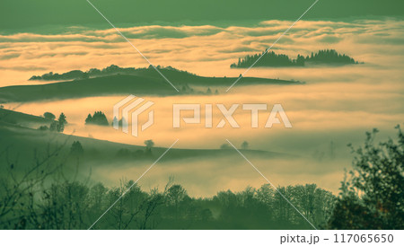 Fantastic view of the tops of the mountain ridge above the clouds 117065650