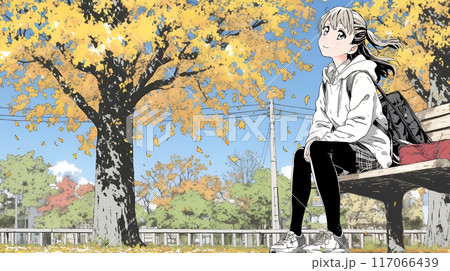 通学路の色づいた銀杏の木の下に腰替える女子高生