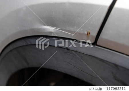 Minor scratches and dent on the body of a car due to accident. Minor scratches and dent on the body of a car due to accident. 117068211