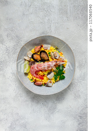 seafood paella, on a plate, traditional Spanish dish, top view, no people, 117068540