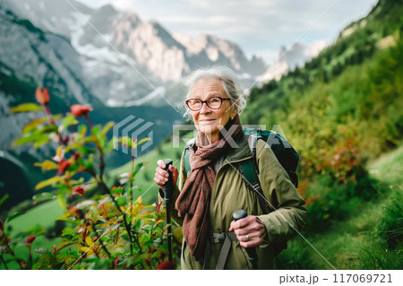 Attractive senior woman walking outdoors in nature, hiking. 117069721