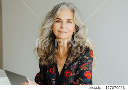Busy middle aged business woman executive using laptop working in office. 117070028