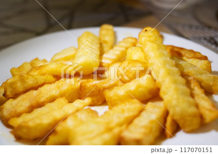 French fries on a white plate, a classic fast food dish French fries on a white plate, a classic fast food dish 117070151