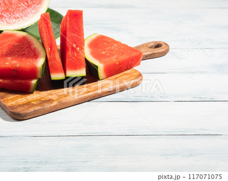 Seedless watermelon slices on wooden background, summer fruit 117071075