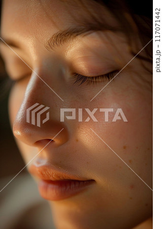 Closeup of peaceful woman's face during Thai massage natural light magazine style 117071442