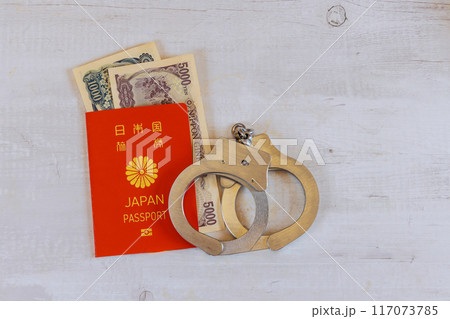 An individual with Japanese passport, Japanese currency yen, with history of corruption, dirty money, financial crimes, in handcuffs An individual with Japanese passport, Japanese currency yen, with history of corruption, dirty money, financial crimes, in handcuffs 117073785