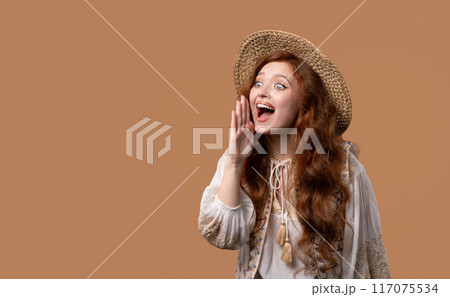 Attention, portrait of young woman shouting, holding hand near open mouth isolated on beige background with copy space for your advertisement. Attention, portrait of young woman shouting, holding hand near open mouth isolated on beige background with copy space for your advertisement. 117075534