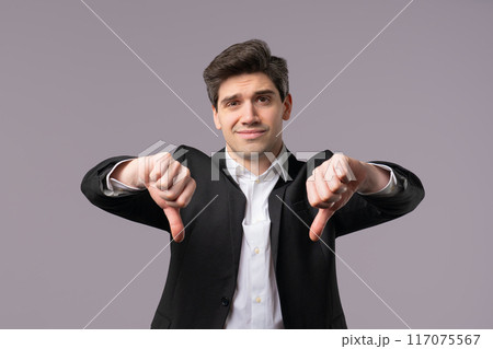 Mature 30s businessman, dislike sign. European manager man thumbs-down on grey Mature 30s businessman, dislike sign. European manager man thumbs-down on grey 117075567