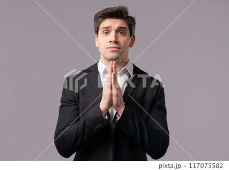 Mature 30s Businessman Praying, Begs Apologize, Guilty on grey. Hopeful Prayer 117075582
