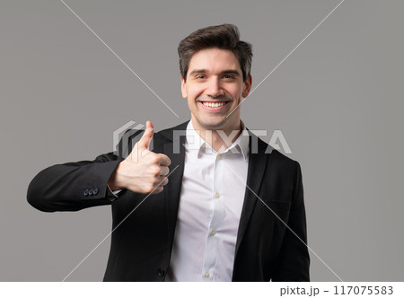 Businessman with hand sign like,thumbs up gesture. Happy ceo leader man on grey 117075583