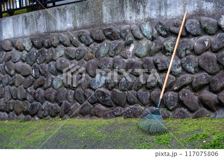 苔の付いた古い丸石の石垣 117075806