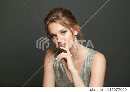 Nice good-looking woman with updo hairstyle and makeup. Young female model portrait 117077000