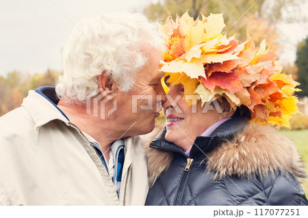 Happy senior couple in autumn park Happy senior couple in autumn park 117077251