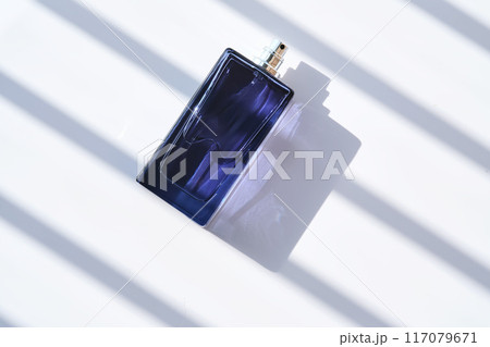 Perfume spray in a blue bottle on a white background. Perfume spray in a blue bottle on a white background. 117079671