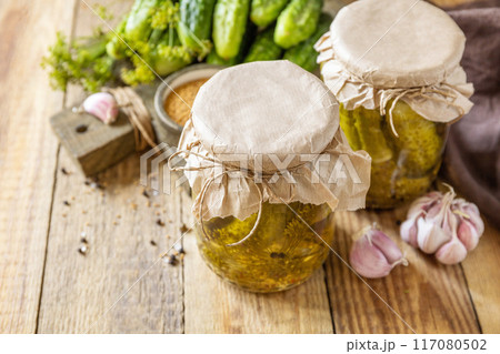Healthy homemade fermented food. Salted pickled cucumbers with mustard preserved canned in glass jar. Home economics, autumn harvest preservation. Copy space. Healthy homemade fermented food. Salted pickled cucumbers with mustard preserved canned in glass jar. Home economics, autumn harvest preservation. Copy space. 117080502