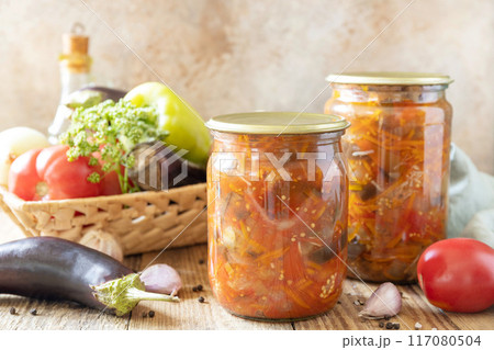 Healthy homemade fermented food. Salad with aubergines and vegetables on a rustic table. Home economics, autumn harvest preservation. Healthy homemade fermented food. Salad with aubergines and vegetables on a rustic table. Home economics, autumn harvest preservation. 117080504