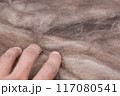 Construction worker thermally insulating house mineral wool attic with glass wool 117080541
