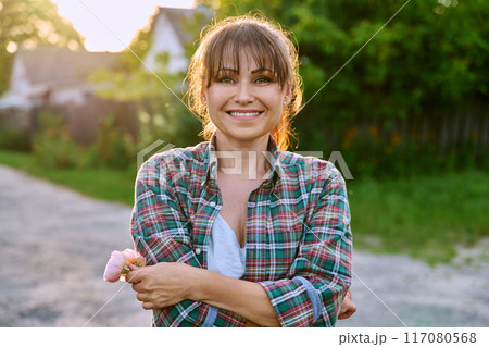 Happy positive smiling middle aged woman, outdoor portrait 117080568