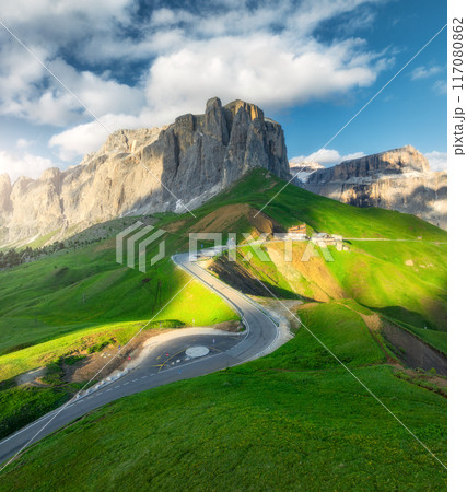 Aerial view of road in alpine mountains at sunset in summer 117080862