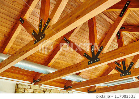 Rustic Wooden Beam Ceiling with Metal Brackets and Air Duct Rustic Wooden Beam Ceiling with Metal Brackets and Air Duct 117082533