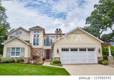 Classic American Suburban Home with Manicured Lawn and Pathway 117082541