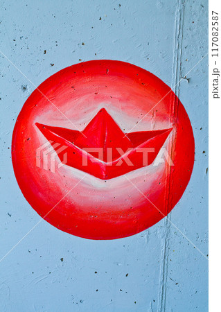 Urban Street Art in Indianapolis - Vibrant Red Paper Boat on Gray Concrete Wall Urban Street Art in Indianapolis - Vibrant Red Paper Boat on Gray Concrete Wall 117082587